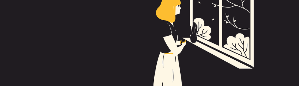 woman standing at window looking at trees holding a coffee cup